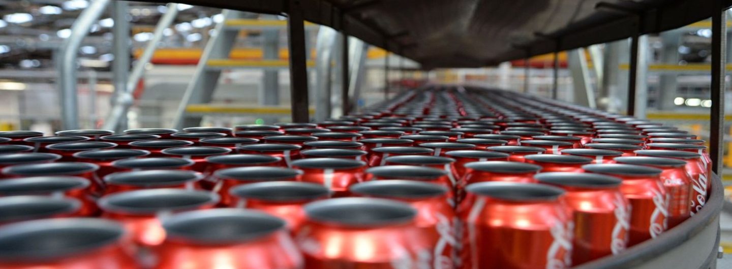 Bloomberg Photo Service 'Best of the Week': Empty Coca-Cola Classic cans move along a conveyor to be filled and sealed at a Coca-Cola Amatil Ltd. production facility in Melbourne, Australia, on Tuesday, Aug. 19, 2014. Coca-Cola Amatil flagged a second consecutive drop in full-year earnings amid weak consumer confidence and rising costs in Indonesia. Photographer: Carla Gottgens/Bloomberg